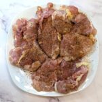 Season garlic butter chicken thighs